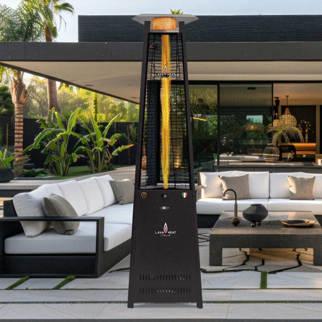 A black The 2G heater standing outdoors in front of sofas.