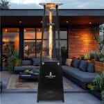 Black Lava Lite heater outside in front of sofas