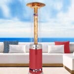 Red Fire Fountain heater outdoors in front of sofas